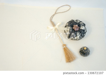 Top view of a pumpkin ornament and broom 130672107