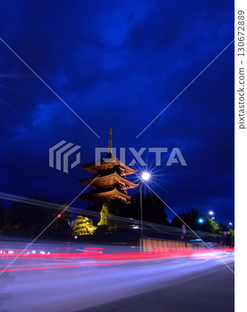 The illuminated five-story pagoda of Toji Temple in Kyoto and the light trails of cars 130672889