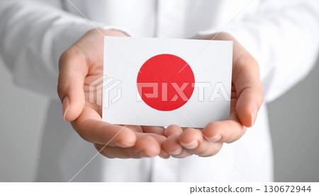 Japanese flag, woman's hand holding the Hinomaru flag, generative AI 130672944