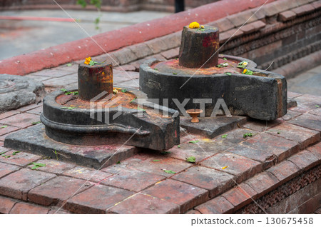 Shiva Lingam with Yoni base in Pashupatinath temple the most holy Hinduism places in Kathmandu, Nepal. Shiva Lingam is a powerful symbol of Lord Shiva in Hinduism. Shiva Lingam with Yoni base in Pashupatinath temple the most holy Hinduism places in Kathmandu, Nepal. Shiva Lingam is a powerful symbol of Lord Shiva in Hinduism. 130675458