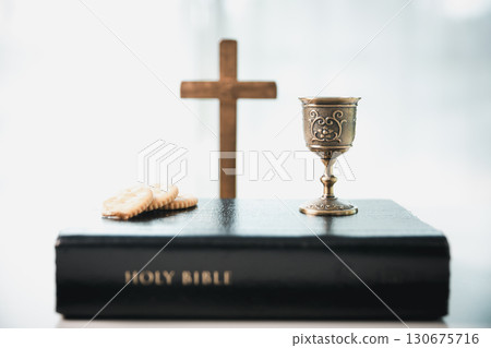 Christianity, holy communion ceremony is sacred act of worship and faith, where bread and wine in chalice symbolize body and blood of Christ in the religious eucharist tradition. Christianity, holy communion ceremony is sacred act of worship and faith, where bread and wine in chalice symbolize body and blood of Christ in the religious eucharist tradition. 130675716