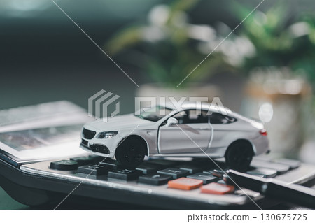 Client legal contract and finance document for business deal involving vehicle, agreements cover car loan, insurance, investment terms, with car key handed over to complete transaction. 130675725