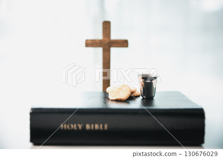 Christianity, holy communion ceremony is sacred act of worship and faith, where bread and wine in chalice symbolize body and blood of Christ in the religious eucharist tradition. Christianity, holy communion ceremony is sacred act of worship and faith, where bread and wine in chalice symbolize body and blood of Christ in the religious eucharist tradition. 130676029