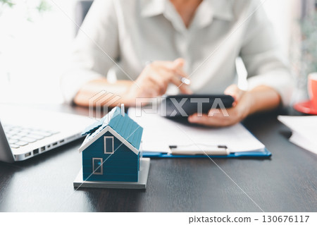Real estate agent agree to buy home to clients agency office. House model, real estate agent, customer discussing for contract to buy house, insurance, loan real estate background. Concept agreement. 130676117