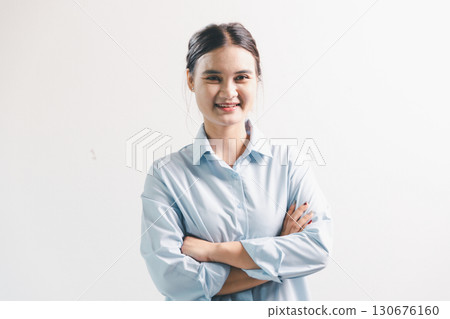 Asian woman rejoicing, looking happy, champion, fist pump gesture, standing over white background. young woman had happy, positive expression on her face, highlighted by bright smile. 130676160