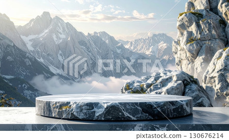 White, snowy mountain peaks and a frozen alpine lake create a stunning winter landscape view under a cold sky 130676214