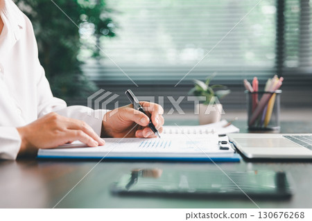 Businesswoman manages finances by using banking and accounting system to calculate costs, taxes, investments, illustrating a business, finance, and real estate concept focused on financial strategy. Businesswoman manages finances by using banking and accounting system to calculate costs, taxes, investments, illustrating a business, finance, and real estate concept focused on financial strategy. 130676268