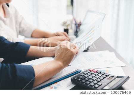 Business meeting, data analytics or women with graph presentation in office. Chart, analysis accounting team brainstorming economy, inflation or solution. business project finance investment concept. 130676409