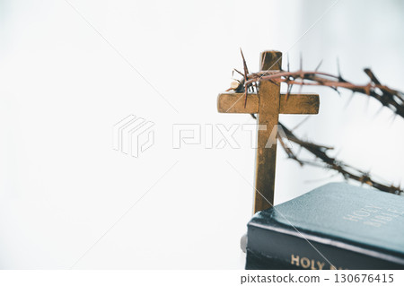Crown of thorns and cross powerful symbols in Christianity, representing holy sacrifice of Jesus Christ in Bible and serving as enduring reminders of faith and core of Christian religion. 130676415