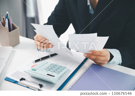 Woman calculating monthly home expenses, taxes, bank account balance and credit card bills payment, Income is not enough for expenses. financial planning, business calculate tax, investment finance. 130676546