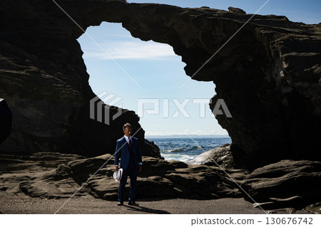 A man in a suit stranded in a sea cave asking for help - a dramatic scene of despair and hope A man in a suit stranded in a sea cave asking for help - a dramatic scene of despair and hope 130676742
