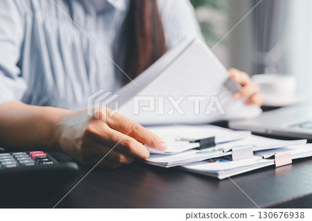 Business woman analyze calculate company financial, tax results office accounting statistics analytical research. calculating business balance prepare tax reduction. Tax deduction planning concept. 130676938