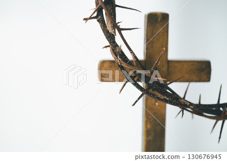 Cross and crown of thorns, often seen in gold crucifix symbols, represent the sacrifice of Jesus Christ-central to Easter message and the foundation of faith in the Christian religion. Cross and crown of thorns, often seen in gold crucifix symbols, represent the sacrifice of Jesus Christ-central to Easter message and the foundation of faith in the Christian religion. 130676945