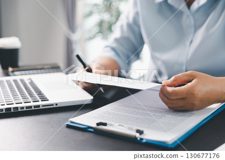 Business person with contract law and paper work for business finance, loan application form, contract real estate and insurance concept. signing contract, working on desk, business document 130677176
