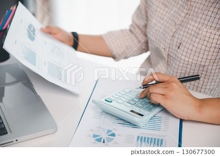 Businesswoman analysis with financial data, marketing business strategy project, Business financing accounting banking concept, finances, calculate about cost to real estate investment, tax system. Businesswoman analysis with financial data, marketing business strategy project, Business financing accounting banking concept, finances, calculate about cost to real estate investment, tax system. 130677300