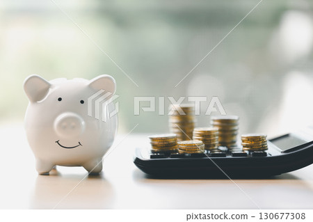 Money box filled with coins, saving cash, banking wisely, making sound investments can build financial wealth, personal finance and overall economy through proper business and currency management. Money box filled with coins, saving cash, banking wisely, making sound investments can build financial wealth, personal finance and overall economy through proper business and currency management. 130677308