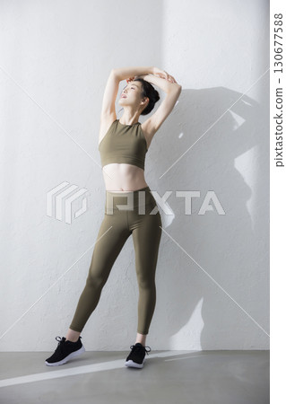一個穿著訓練服伸展的女人 130677588
