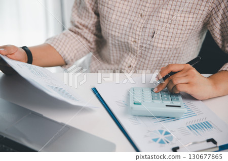 Businesswoman analysis with financial data, marketing business strategy project, Business financing accounting banking concept, finances, calculate about cost to real estate investment, tax system. Businesswoman analysis with financial data, marketing business strategy project, Business financing accounting banking concept, finances, calculate about cost to real estate investment, tax system. 130677865