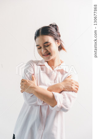 Asian woman rejoicing, looking happy, champion, fist pump gesture, standing over white background. young woman had happy, positive expression on her face, highlighted by bright smile. 130677868