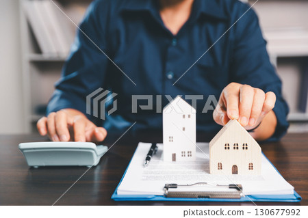 Female hand holds small miniature toy house, symbolizing woman dream of moving into her own home-real estate concept represents property investment, mortgage planning, insurance for secure future. Female hand holds small miniature toy house, symbolizing woman dream of moving into her own home-real estate concept represents property investment, mortgage planning, insurance for secure future. 130677992