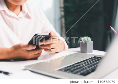 Closeup of woman holding smartphone hand shows using mobile phone technology browse online shopping, social media, engaging in fast-paced world of cyberspace. online shopping, social media network 130678079
