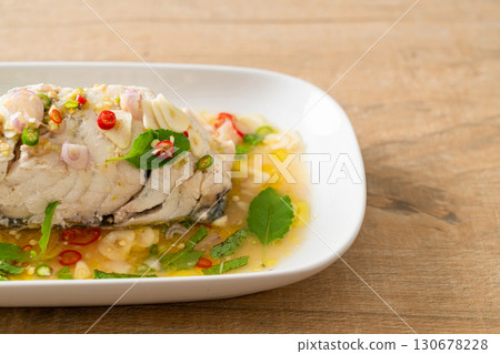 steamed sea bass fish with herbs 130678228