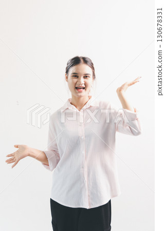 Asian woman rejoicing, looking happy, champion, fist pump gesture, standing over white background. young woman had happy, positive expression on her face, highlighted by bright smile. Asian woman rejoicing, looking happy, champion, fist pump gesture, standing over white background. young woman had happy, positive expression on her face, highlighted by bright smile. 130678331