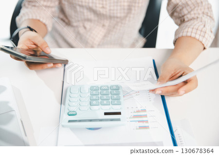 Woman calculating monthly home expenses, taxes, bank account balance and credit card bills payment, Income is not enough for expenses. financial planning, business calculate tax, investment finance. 130678364