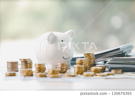 Money box filled with coins, saving cash, banking wisely, making sound investments can build financial wealth, personal finance and overall economy through proper business and currency management. Money box filled with coins, saving cash, banking wisely, making sound investments can build financial wealth, personal finance and overall economy through proper business and currency management. 130678365
