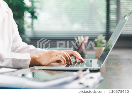 Businesswoman manages finances by using banking and accounting system to calculate costs, taxes, investments, illustrating a business, finance, and real estate concept focused on financial strategy. 130678450