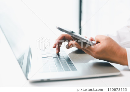 Close-up businesswoman using smart mobile phone at office table, female student is home studying online e-learning, searching for information on internet, engaging with social networks. 130678533