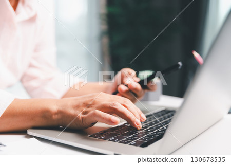 Closeup of woman holding smartphone hand shows using mobile phone technology browse online shopping, social media, engaging in fast-paced world of cyberspace. online shopping, social media network 130678535