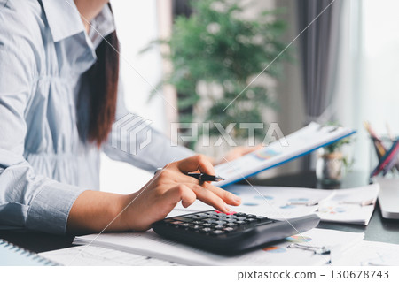 Business woman analyze calculate company financial, tax results office accounting statistics analytical research. calculating business balance prepare tax reduction. Tax deduction planning concept. 130678743