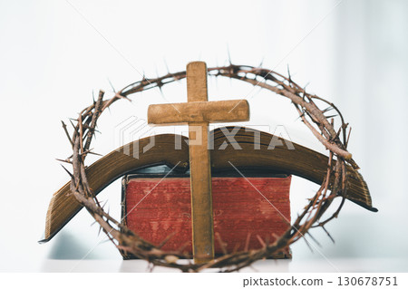 Crown of thorns and cross powerful symbols in Christianity, representing holy sacrifice of Jesus Christ in Bible and serving as enduring reminders of faith and core of Christian religion. 130678751