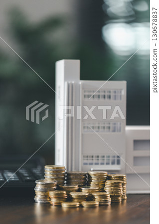 House model placed beside money coins illustrates concept of saving and financial planning for buying home, highlighting investment, mortgage options, home loans, refinancing, smart finance strategies 130678837