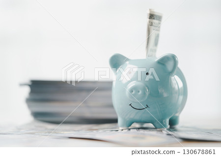 Money box filled with coins, saving cash, banking wisely, making sound investments can build financial wealth, personal finance and overall economy through proper business and currency management. Money box filled with coins, saving cash, banking wisely, making sound investments can build financial wealth, personal finance and overall economy through proper business and currency management. 130678861