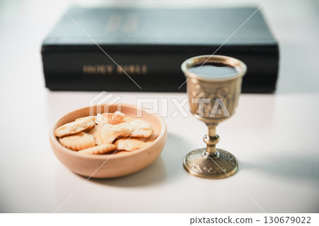 Christianity, holy communion ceremony is sacred act of worship and faith, where bread and wine in chalice symbolize body and blood of Christ in the religious eucharist tradition. Christianity, holy communion ceremony is sacred act of worship and faith, where bread and wine in chalice symbolize body and blood of Christ in the religious eucharist tradition. 130679022