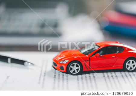 Client legal contract and finance document for business deal involving vehicle, agreements cover car loan, insurance, investment terms, with car key handed over to complete transaction. 130679030