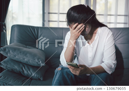 Despair sorrow person in empty dark room, Depressed young woman covering face with hands. Young woman coping with distress covering face. mental health concept. Boring sad upset frustrated stressed. Despair sorrow person in empty dark room, Depressed young woman covering face with hands. Young woman coping with distress covering face. mental health concept. Boring sad upset frustrated stressed. 130679035