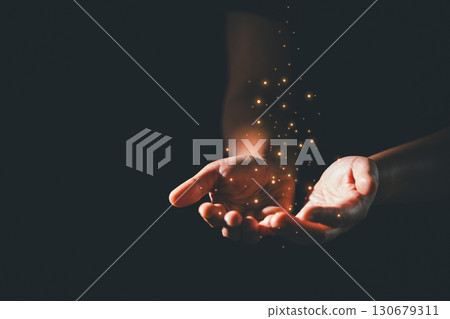 Dark silence of the church, a Christian lifts their hand in prayer to God, a symbol of worship, faith, and hope-embracing the spiritual concept of religion and believing in Jesus Christ. 130679311