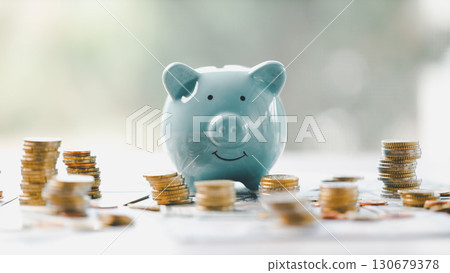 Money box filled with coins, saving cash, banking wisely, making sound investments can build financial wealth, personal finance and overall economy through proper business and currency management. Money box filled with coins, saving cash, banking wisely, making sound investments can build financial wealth, personal finance and overall economy through proper business and currency management. 130679378