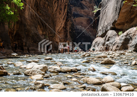 Hiking the Narrows of Zion National Park along the Virgin River at midday 130679410