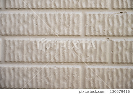 Textured white brick wall with a unique pattern seen up close in a well-lit indoor space 130679416