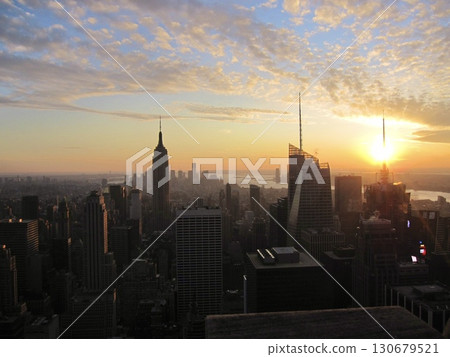 Manhattan Island at dusk, bathed in a beautiful sunset seen from the observation deck. Advertising, tourist brochures, and website materials. 130679521