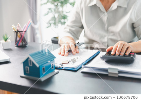 Real estate agent agree to buy home to clients agency office. House model, real estate agent, customer discussing for contract to buy house, insurance, loan real estate background. Concept agreement. 130679706