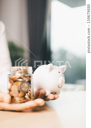 Hand holding coin symbolizes saving, investment, smart finance decisions money, currency, cash financial wealth, driving business growth, economic stability, long-term success in banking economy. Hand holding coin symbolizes saving, investment, smart finance decisions money, currency, cash financial wealth, driving business growth, economic stability, long-term success in banking economy. 130679880