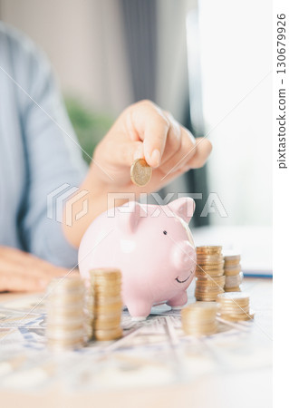 Hand holding coin symbolizes saving, investment, smart finance decisions money, currency, cash financial wealth, driving business growth, economic stability, long-term success in banking economy. 130679926