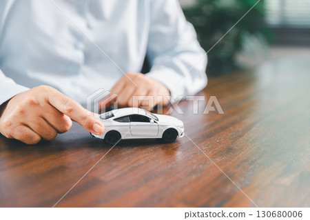 Dealership service desk, professional car salesman assists client with sale, finance documents for vehicle, ensuring smooth business transaction in retail transportation sector through signed contract Dealership service desk, professional car salesman assists client with sale, finance documents for vehicle, ensuring smooth business transaction in retail transportation sector through signed contract 130680006