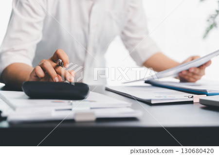 Business woman analyze calculate company financial, tax results office accounting statistics analytical research. calculating business balance prepare tax reduction. Tax deduction planning concept. 130680420