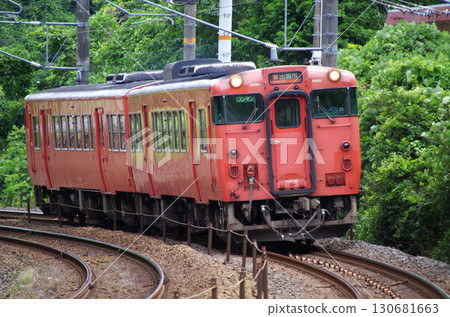 兩輛朱紅色（原日本國家鐵路顏色）的 Kiha 40 系列 Kiha 47 柴油車在山陰本線的彎道中穿梭。 130681663